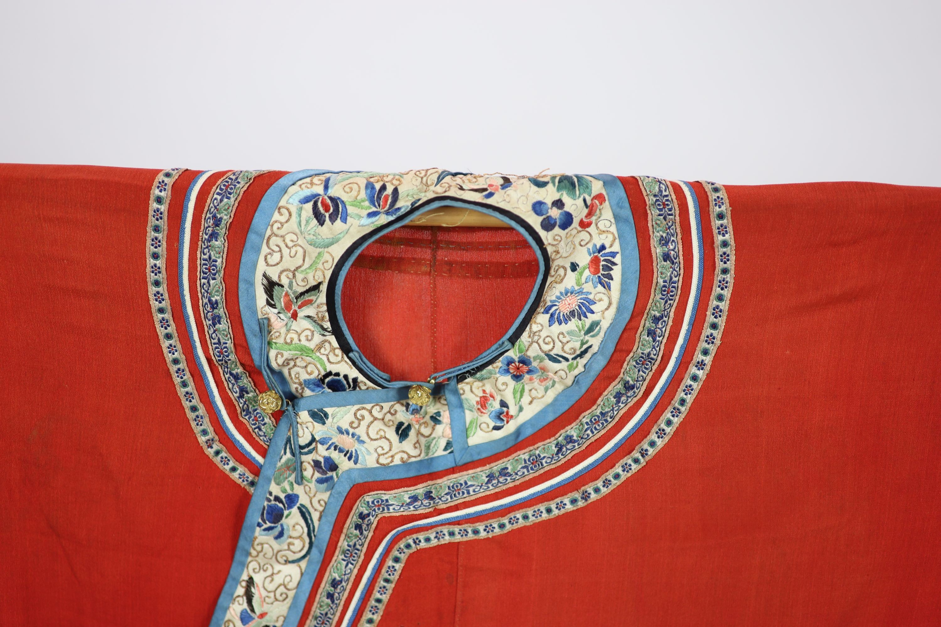 A Chinese red silk robe, late 19th century, 102cm drop